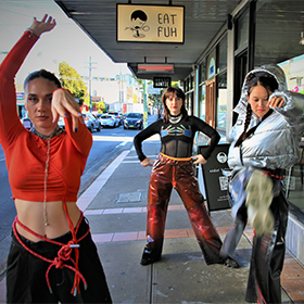 Three girls dance on the street